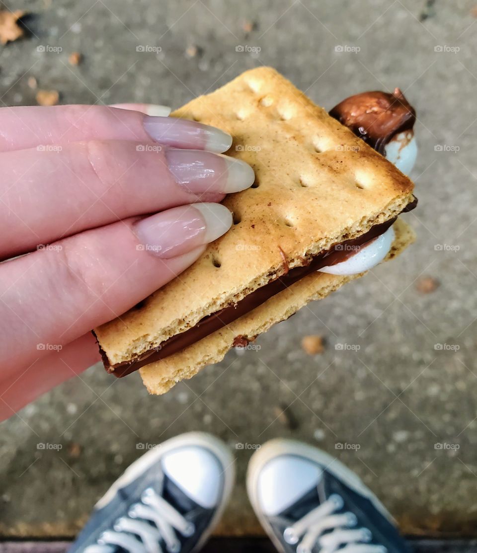 Eating a s'more.