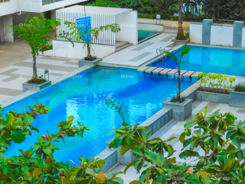 Swimming pool photography - Structure of swimming pool is very beautiful and colourful..surrounding is filled with Nature. Pool designing is attractive.