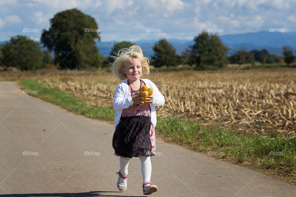 Girl holding corn in hand