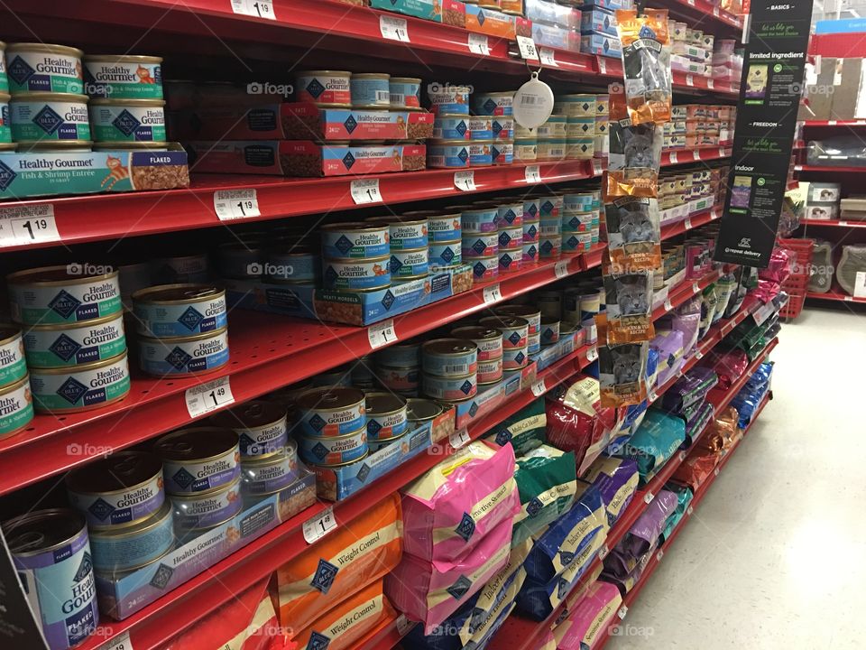 Dog or cat food at a pet store with blood red shelving. 