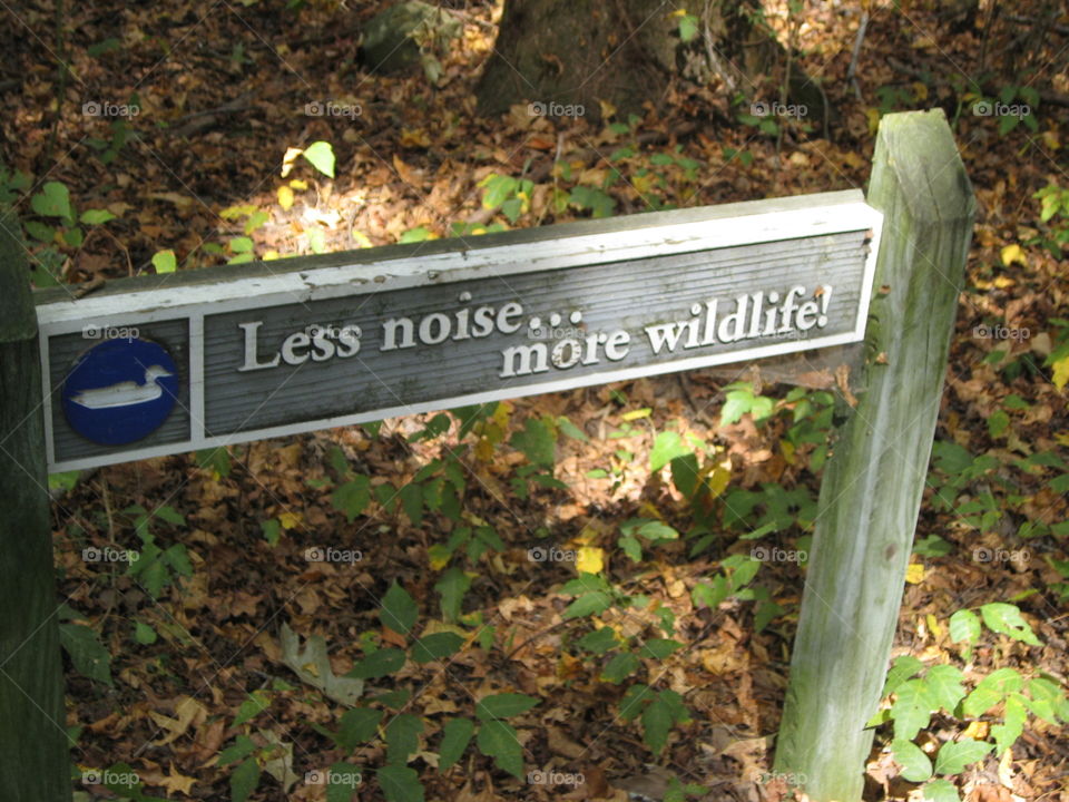 A sign listed in the trail of the wildlife refuge, wooden sign that speaks for itself. Sunny day. 