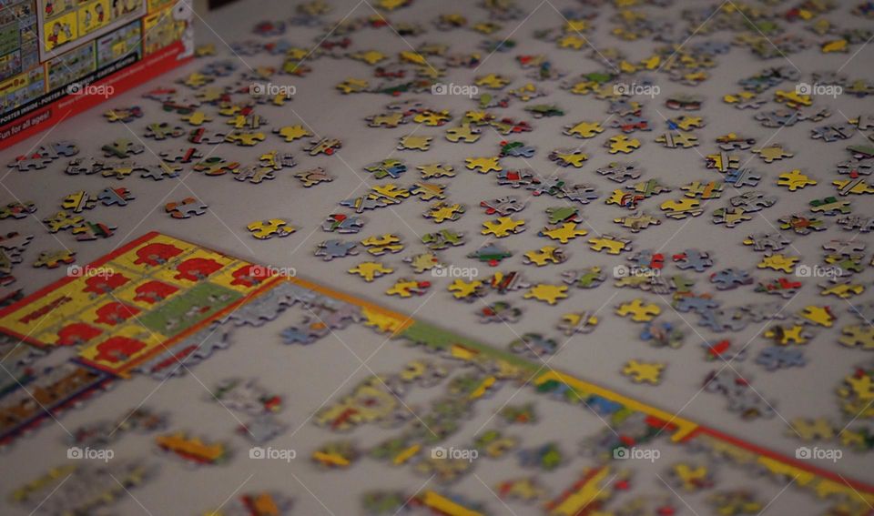 Making puzzles on a desk, wintertime activities indoors, putting together a puzzle 