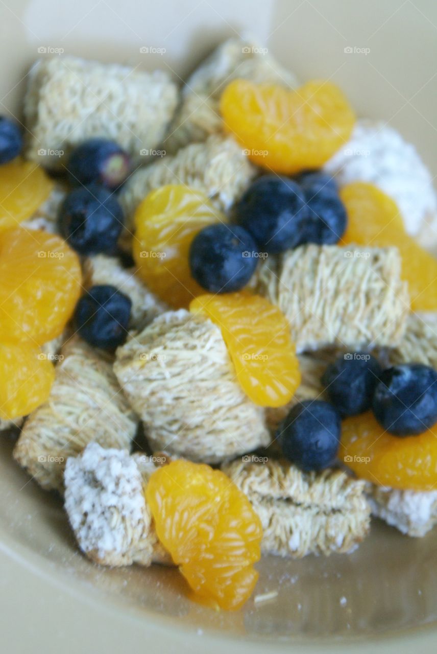 Happy tummy. Healthy meal of oranges, blueberries, and wheat cereal 