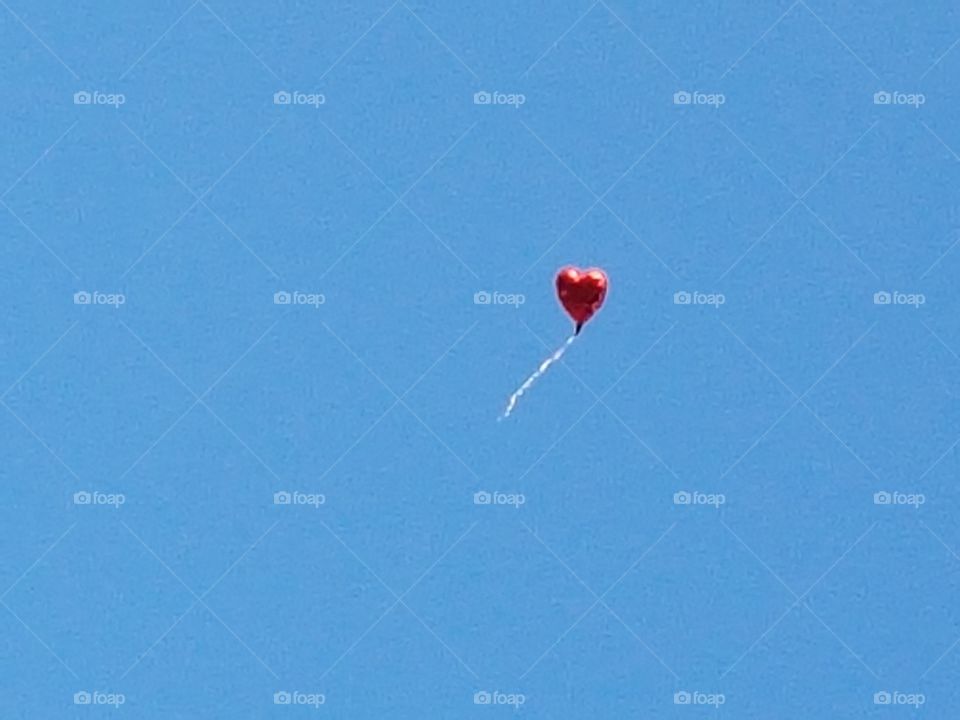 Heart shaped balloon breaking free