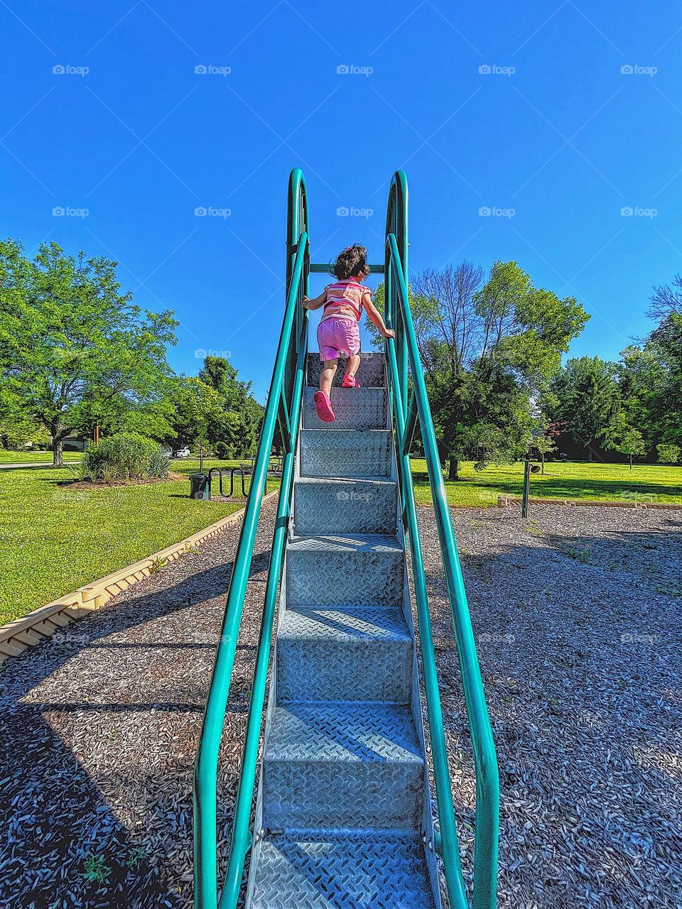 Toddler going down slide, toddler using slide at park