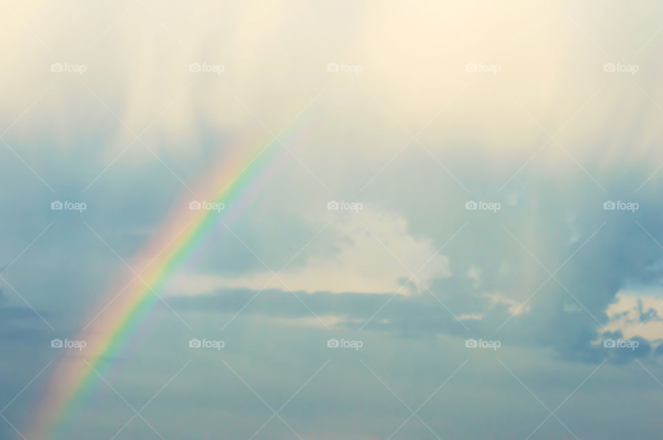 Rainbow in the clouds dreamlike tranquility background nephology, light and physics inspiring art and tranquility photography 