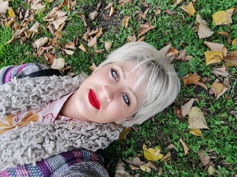 A girl lying down on grass.