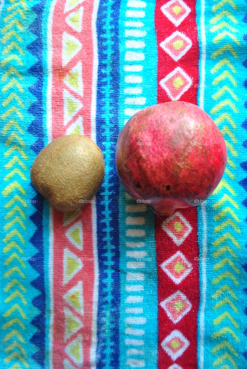 A kiwi and a pomegranate