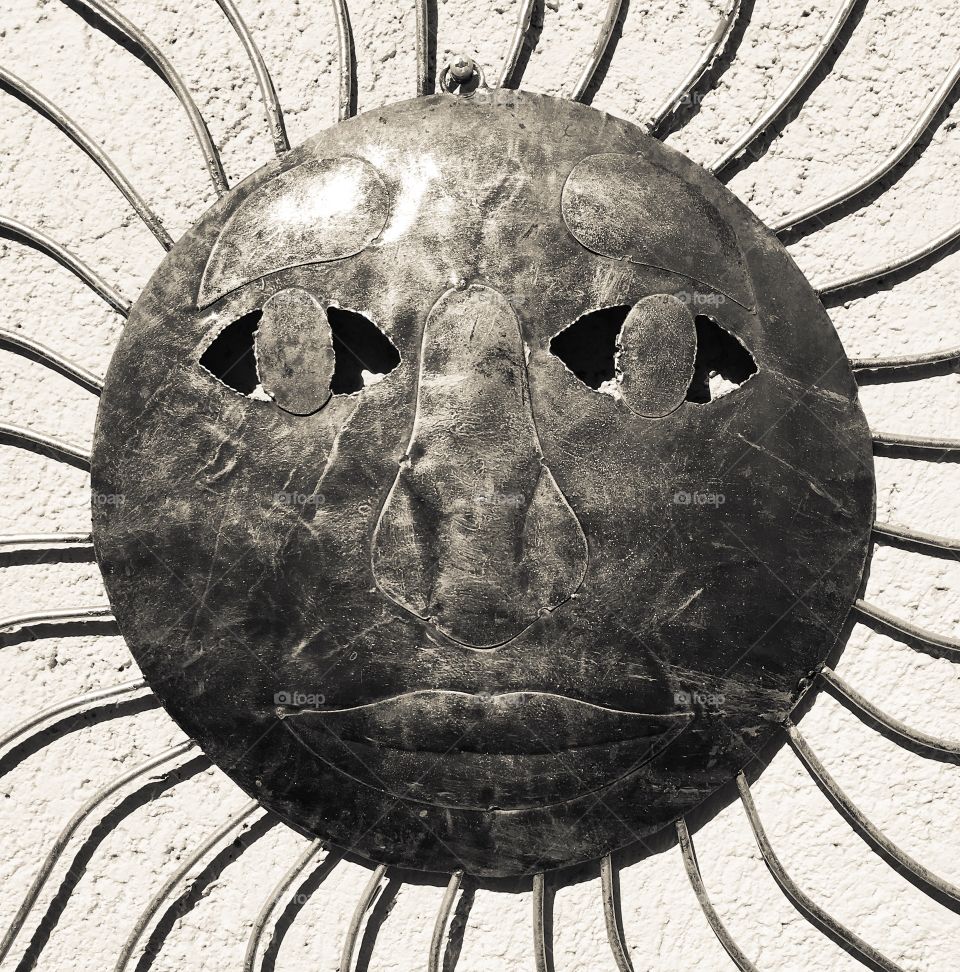 Metal sun with face art