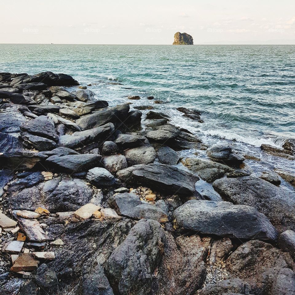 Scenic view of coastline with stones