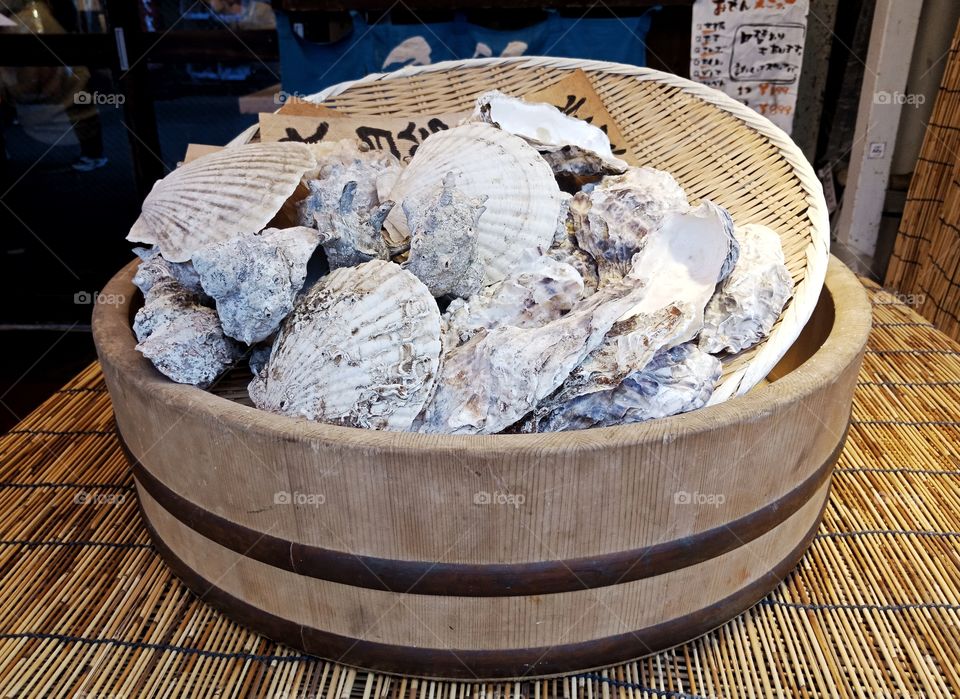 oyster in big bowl outside a seafood restaurant, Tokyo, Japan