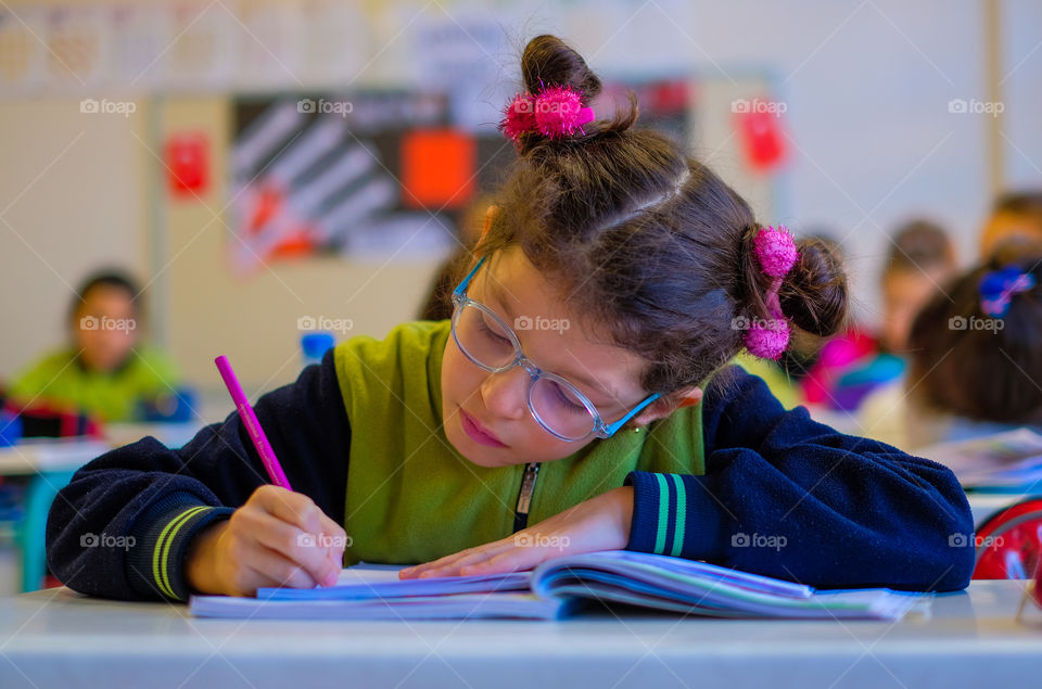 A colorful student on a classroom desk