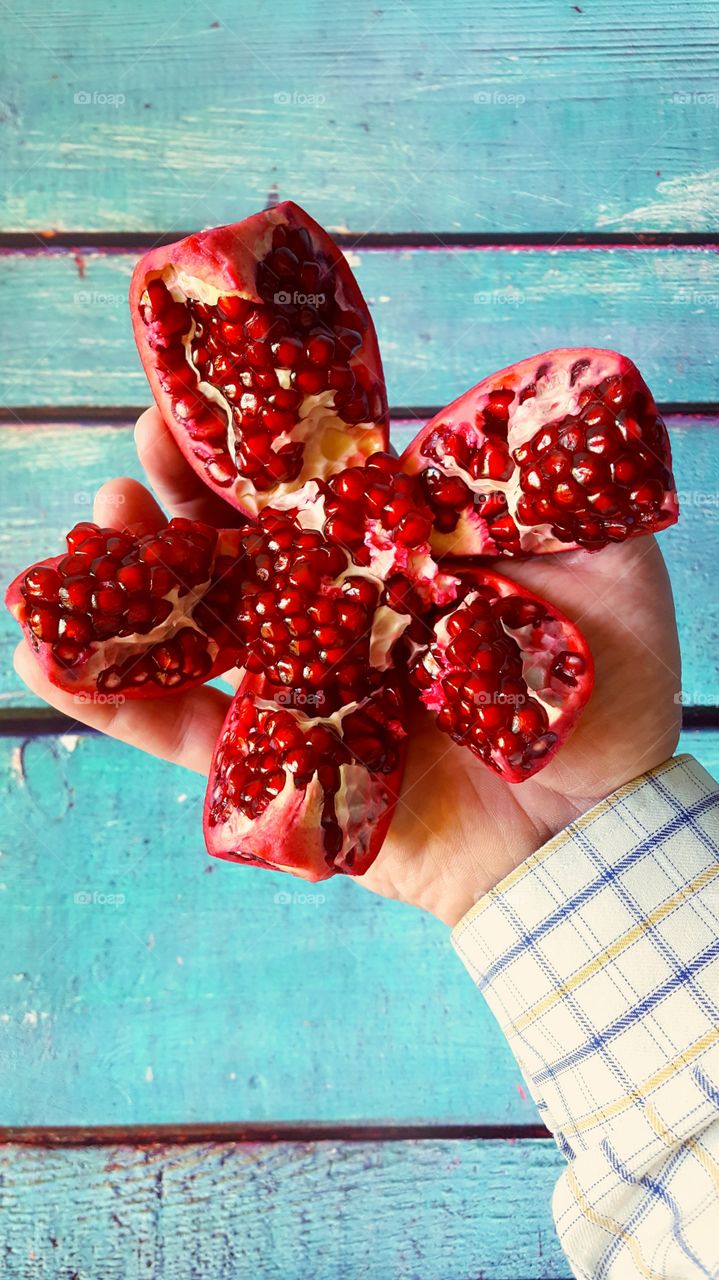 A person holding pomegranate