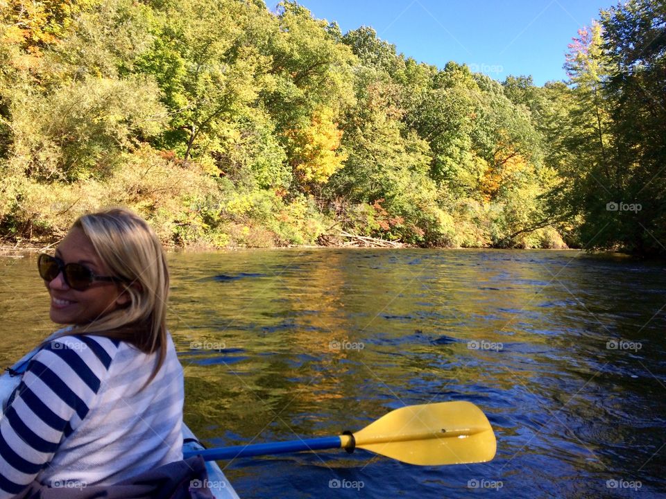 Smiling woman enjoying boating in lake