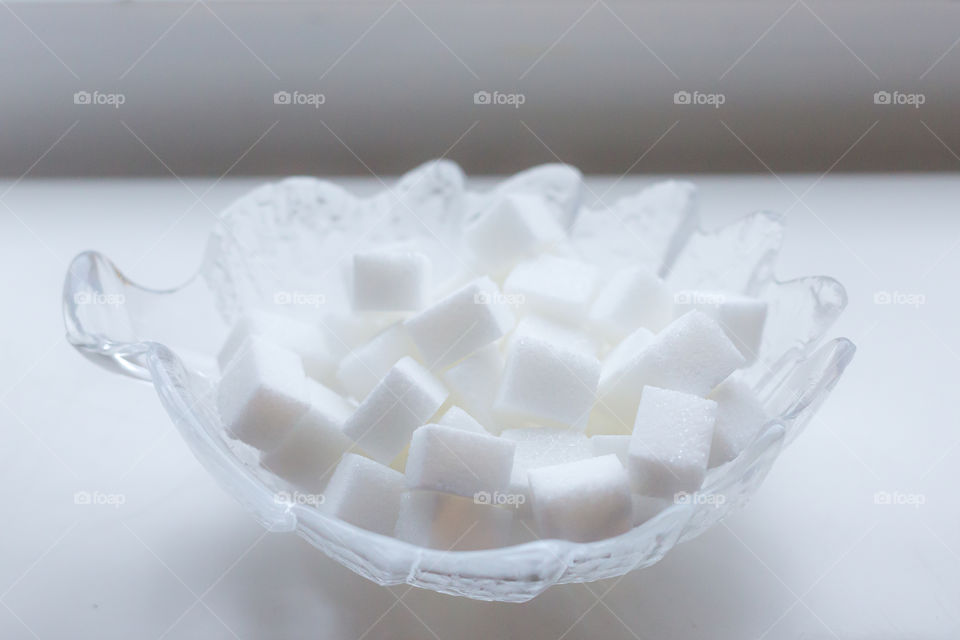 Sugar cubes in a glass bowl 