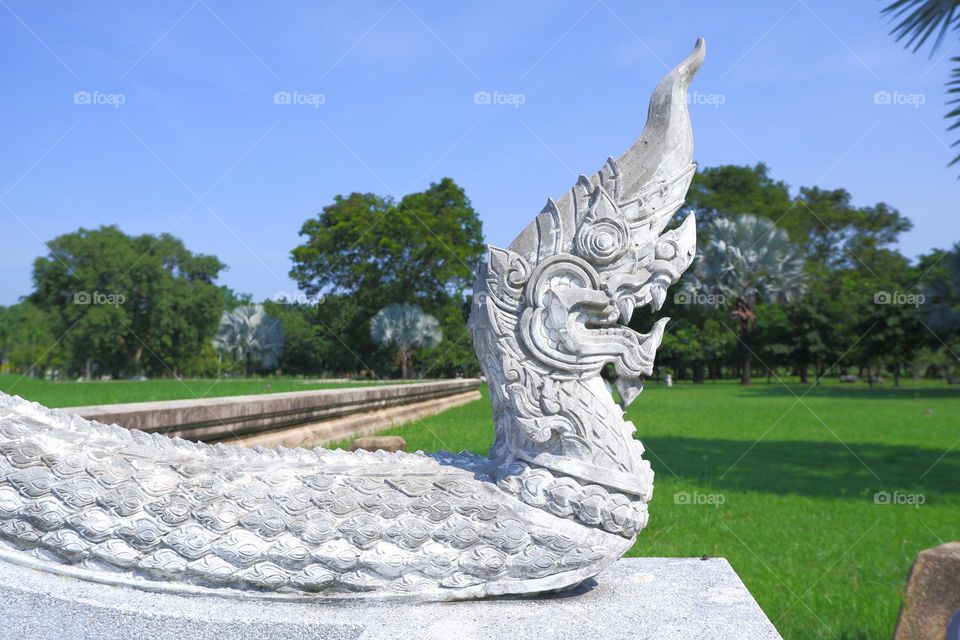 A stucco sculpture shaped like a snake in the sun.