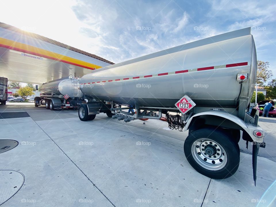 Tanker truck delivering fuel to a gas station