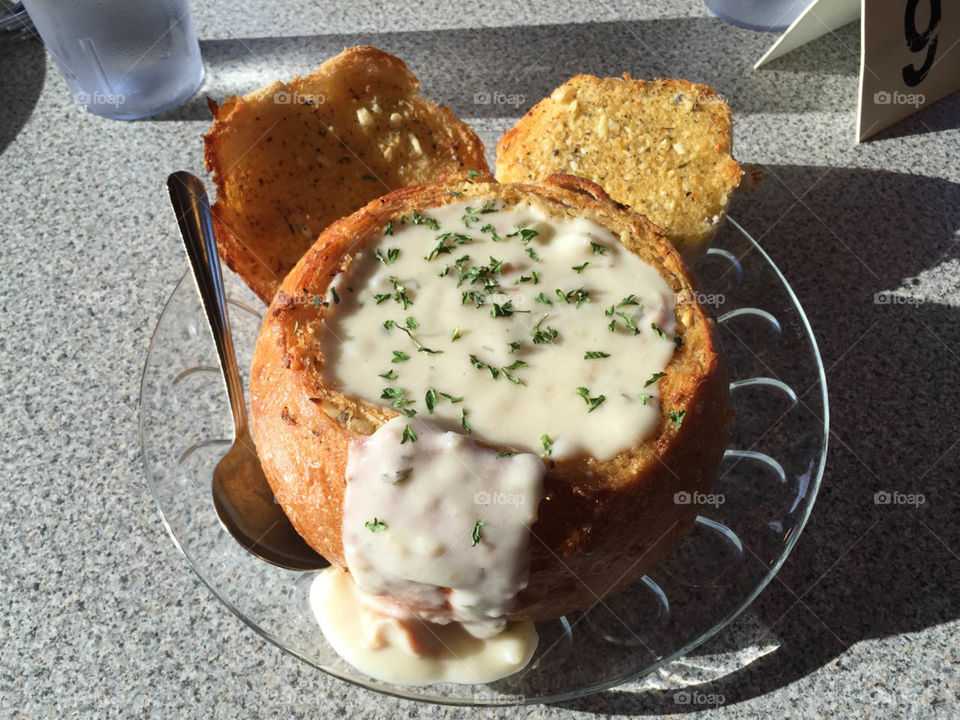 Clam chowder in a bread bowl. Golden brown bread bowl, clam chowder. Square crop. Unedited. 