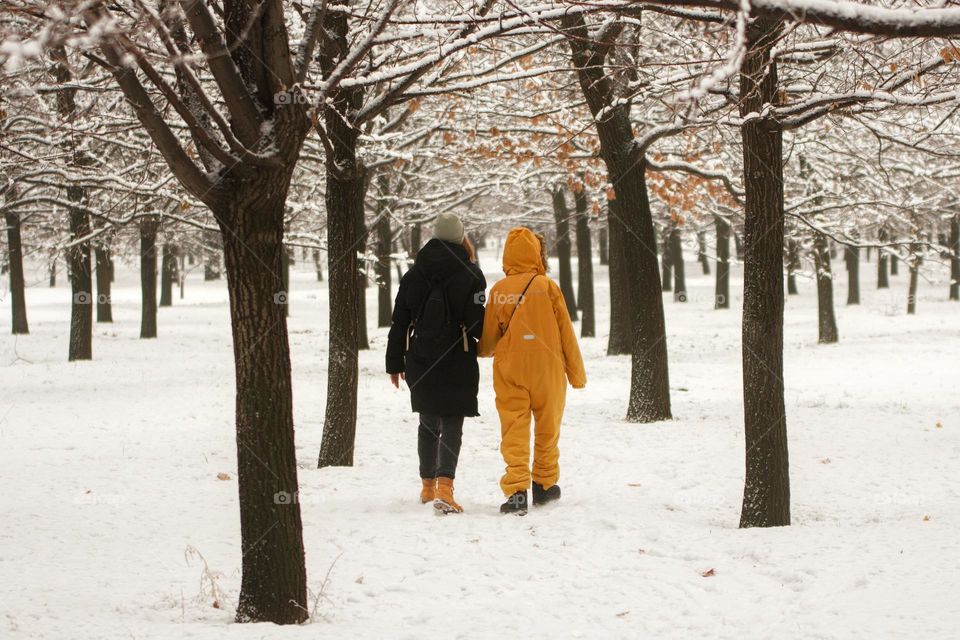 Mom and daughter are walking in the park
