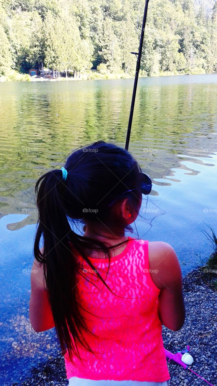 girl fishing at lake