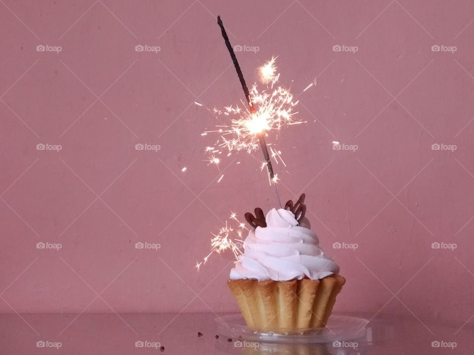 Pink cake. Sparkler. Birthday.