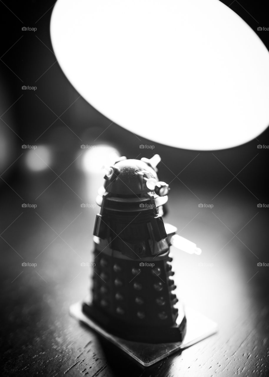 Backlit Dalek figurine that is plotting to take over the world. 