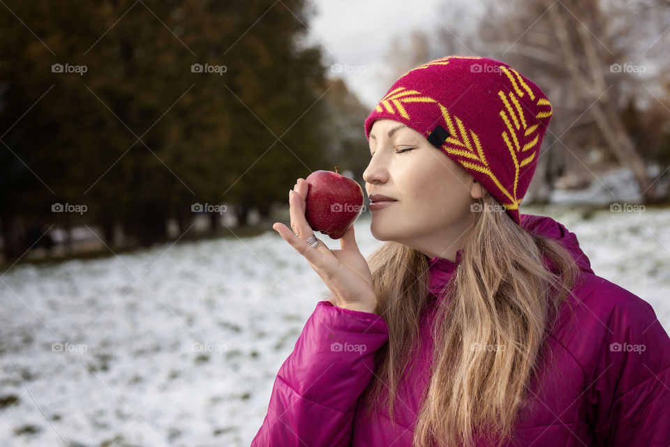 Girl with apple outdoors