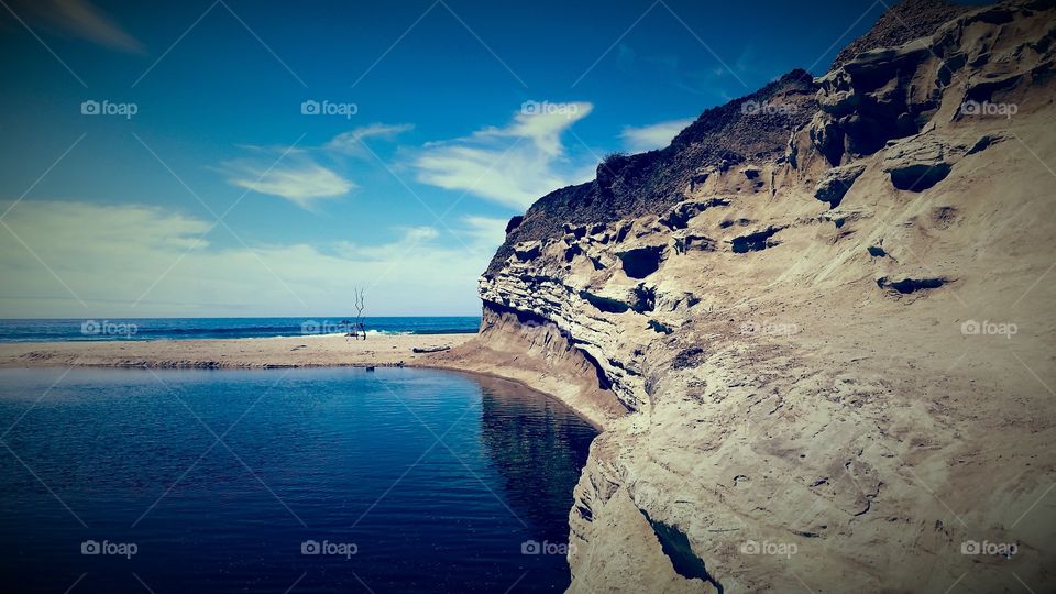 Lagoon and a beach. Sandstone outcropping on a Pacific beach.